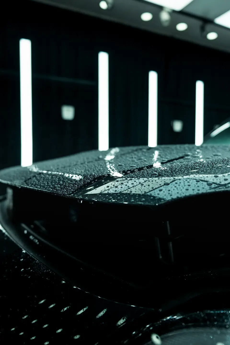 Tight water beads on a dark hood