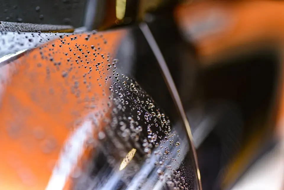 Water drops on glossy paint, close-up