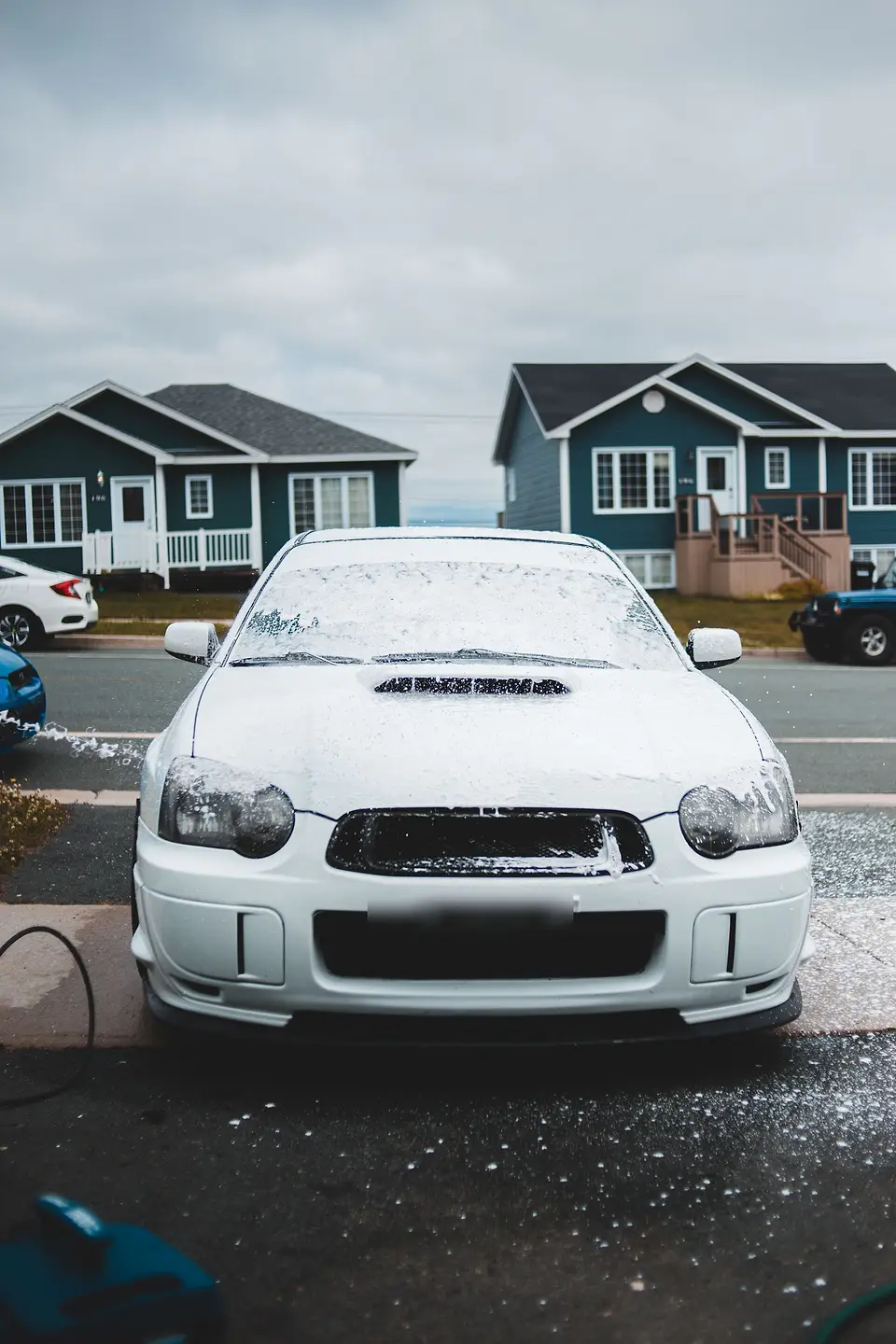 Foam-covered car parked on a residential street