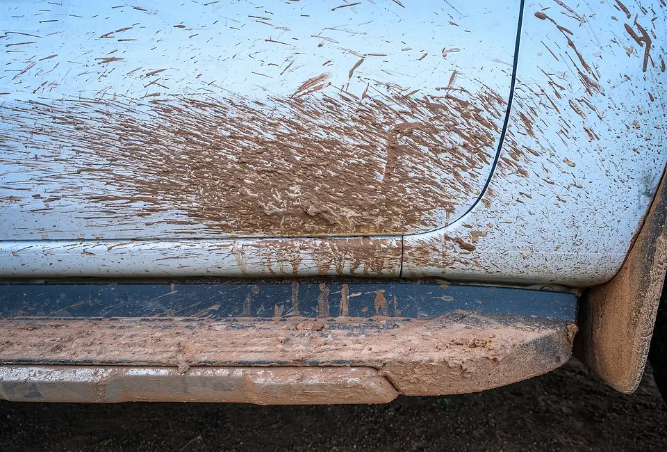 Mud splashed along the side of a vehicle