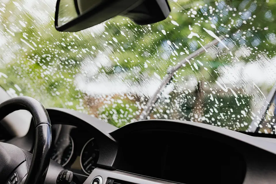View from the driver's seat of a windshield being washed